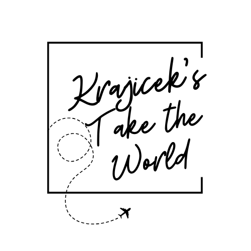 Logo featuring the text 'Krajicek's Take the World' with a stylized path and airplane graphic.